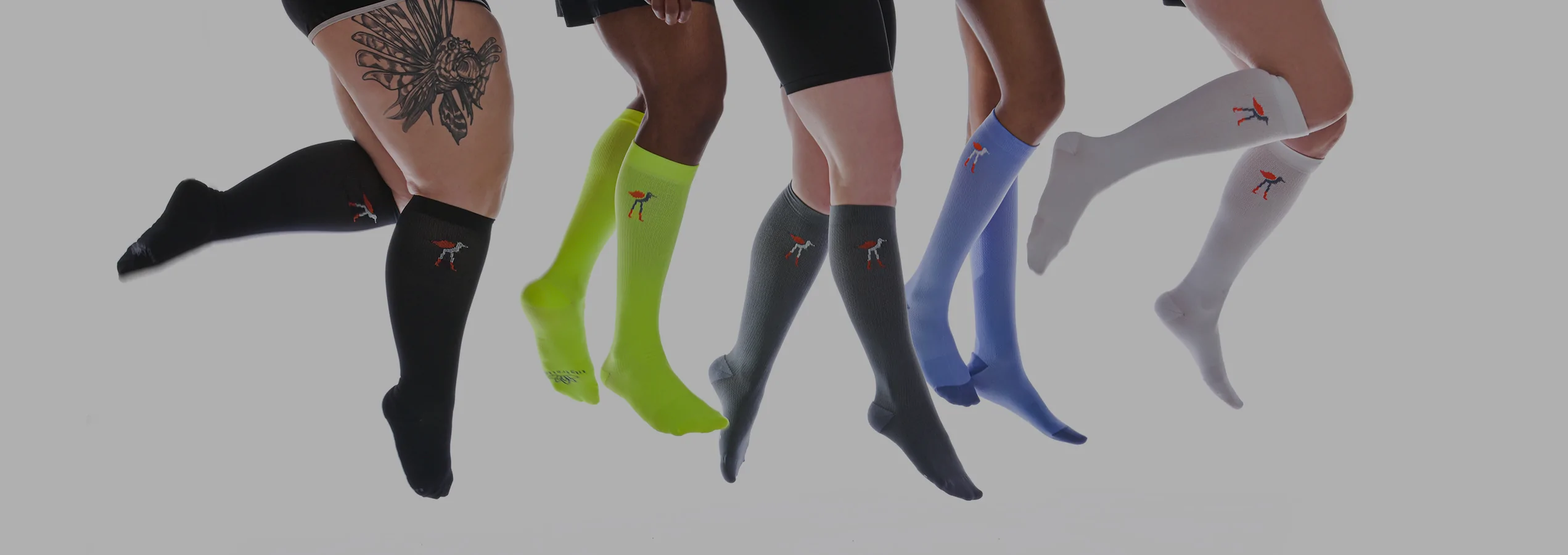 A group of compression-sock-wearing legs float in the air.