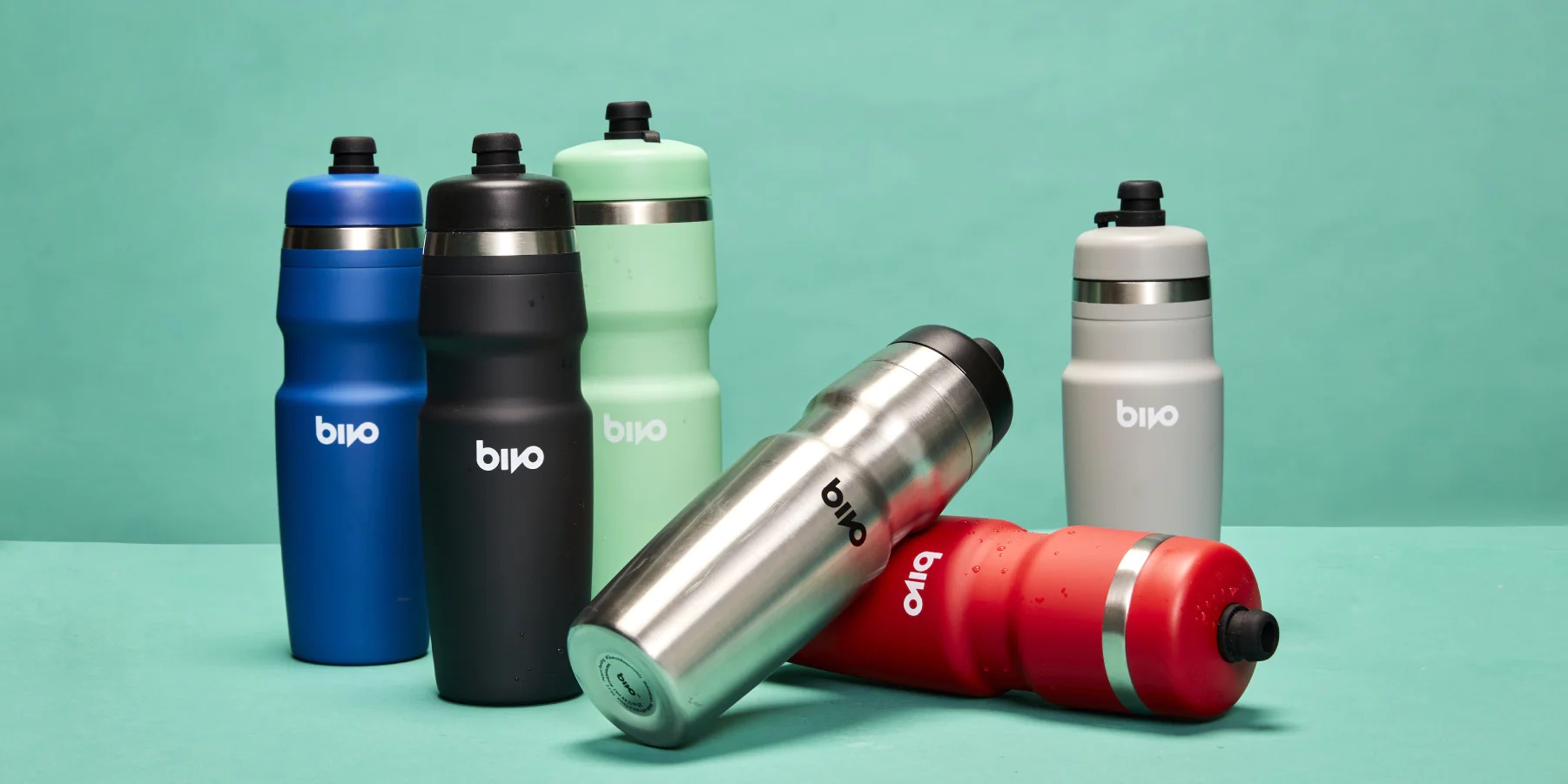 Multi-colored metal water bottles shaped to fit the form of bicycle carriers.