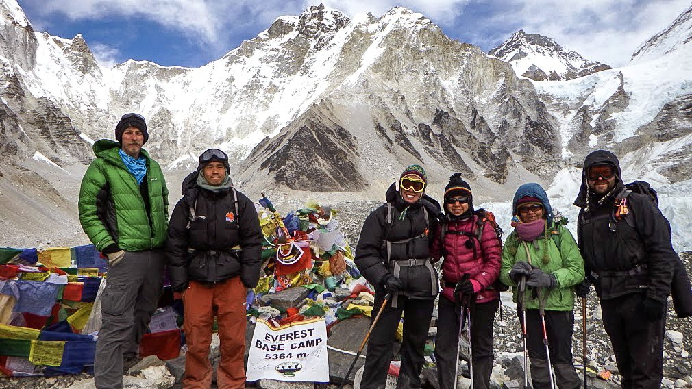 a group of people stand at Everest Basecamp