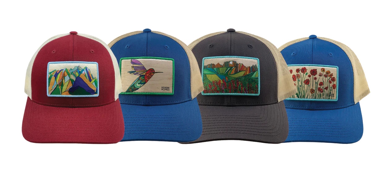 a row of trucker hats with art on them